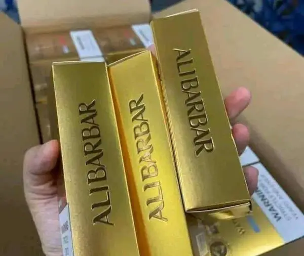 Premium gold packaging of AuburBar cannabis products showcased in a hand, highlighting quality and luxury for Tijuana dispensary customers.